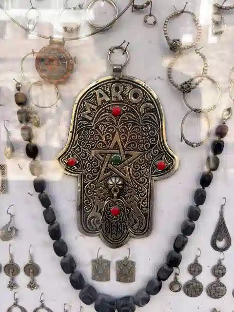 Hand of Fatima Morocco — collection of Hamsa Khamsa amulets in silver and brass in a Moroccan souk, Fes medina