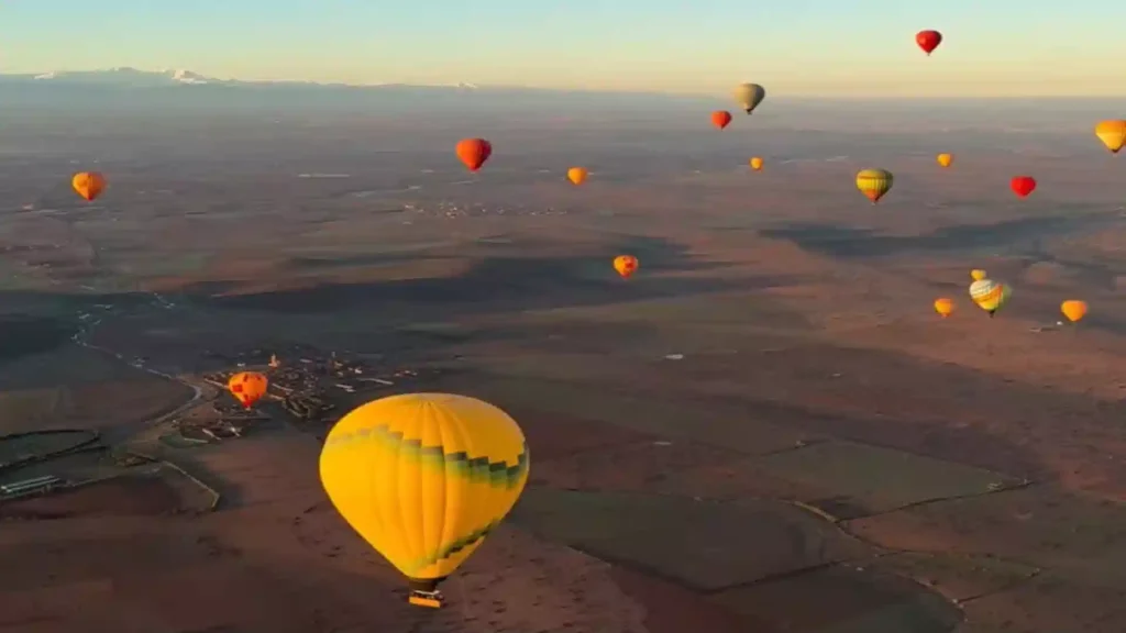 Hot air balloon over Marrakech at sunrise with Atlas Mountains — things to do in Marrakech 2026, Over Morocco Tours.