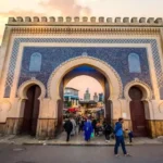 Iconic Bab Bou Jeloud blue tile gate leading into the historic Fes Medina answering what does Medina mean.
