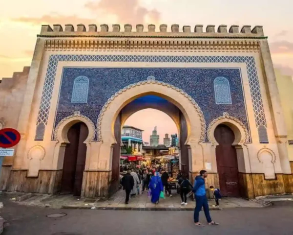 Iconic Bab Bou Jeloud blue tile gate leading into the historic Fes Medina answering what does Medina mean.