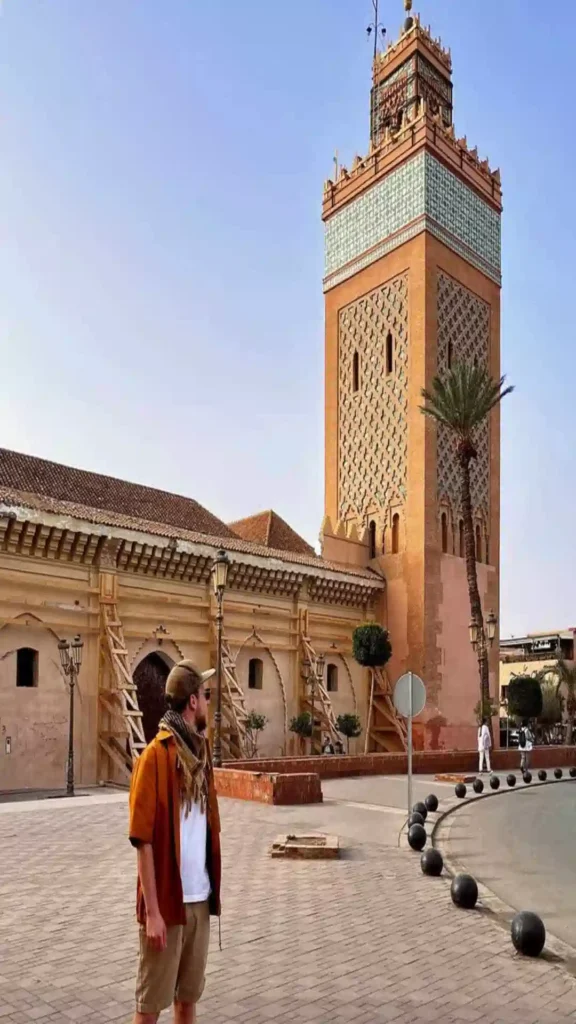 A traveler standing in the open-air courtyard of El Badi Palace featuring detailed geometric zellige tilework in every corner.is marrakech worth visiting