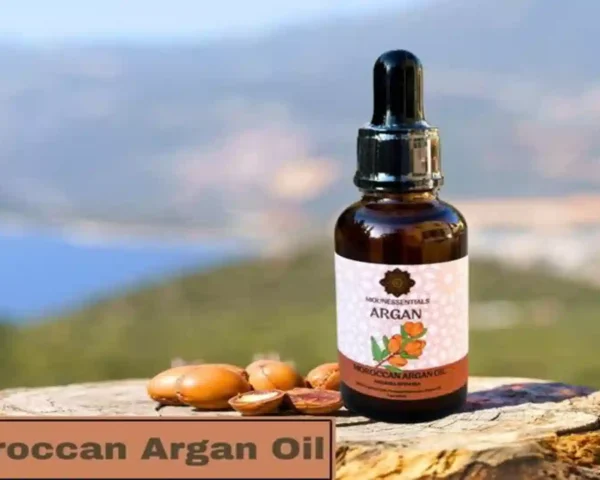 Moroccan argan oil glass bottle with dropper resting on a tree trunk against a scenic background