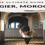 A travel guide graphic titled "The Ultimate Guide to Tangier, Morocco" showing a traveler walking through an intricately tiled Moroccan palace hallway. things to do in Tangier