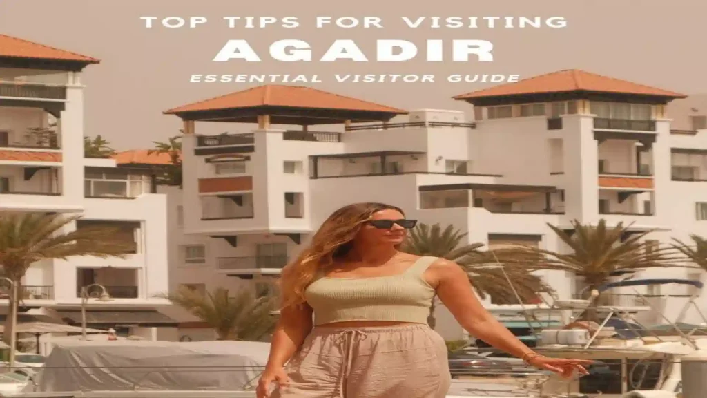 A woman standing in front of luxury boats and modern white buildings along the Agadir Marina promenade. things to do in Agadir Morocco