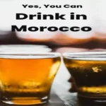 A Pinterest graphic with bold text overlay reading "Yes, You Can Drink in Morocco" above two blurred glasses of draft beer. alcohol in Morocco.